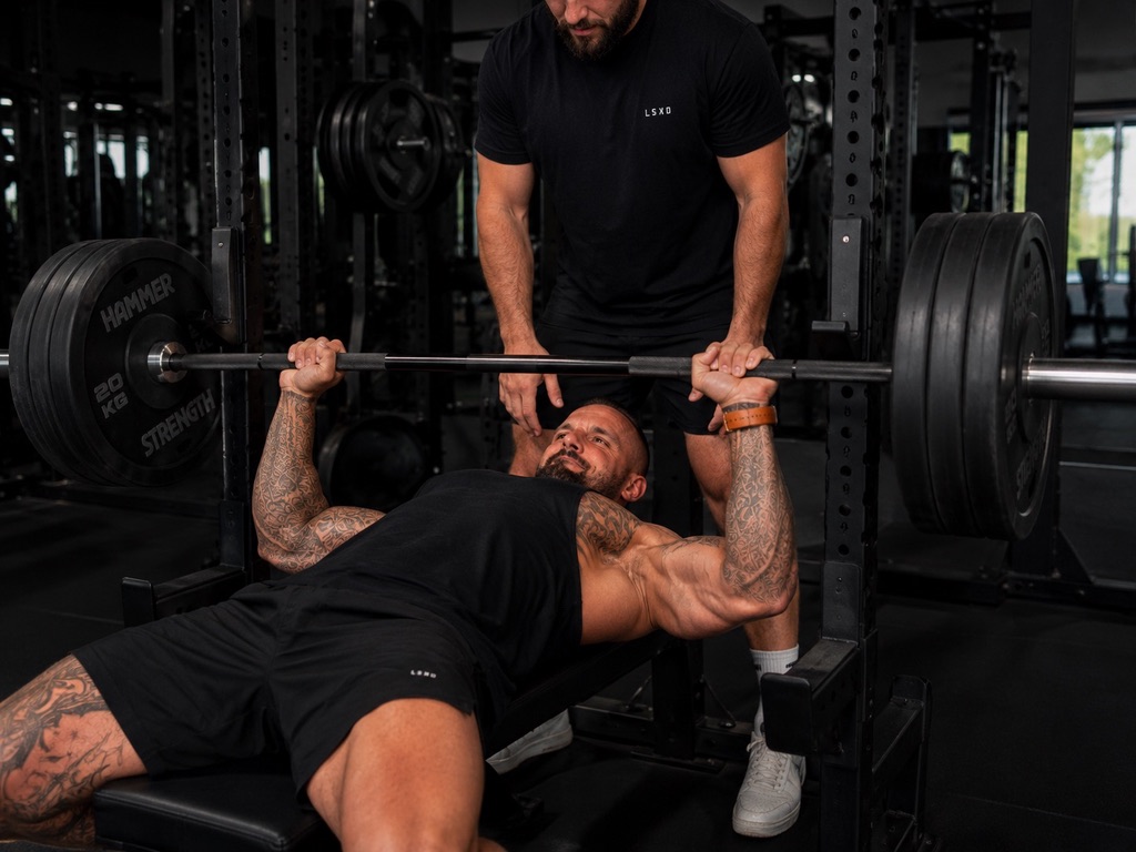 Personal training session — bench press coaching at Raw Fitness